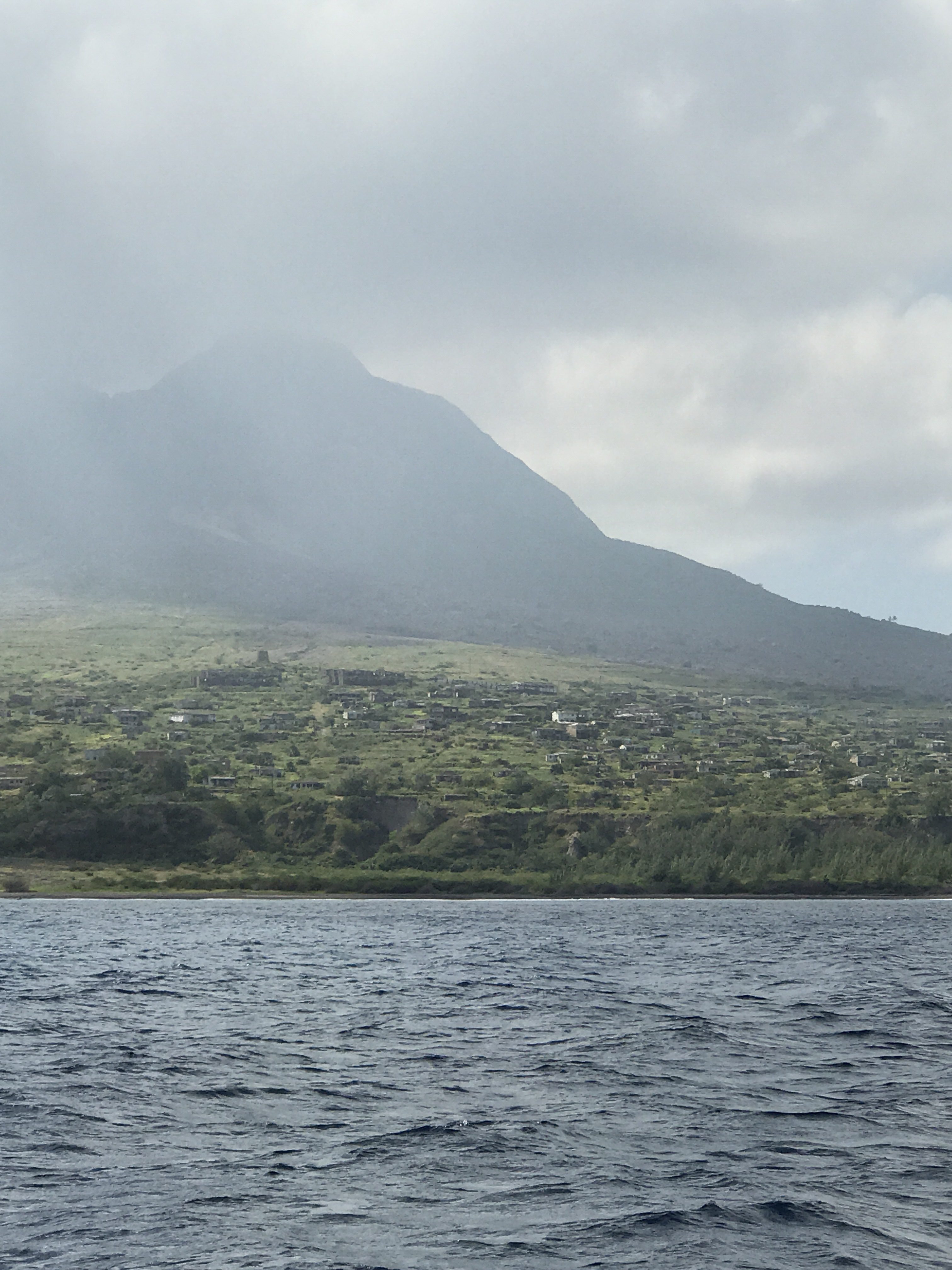The evacuated capital of Montserrat looming under the still active volcano